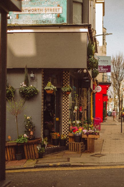 A floral display outside a florist shop on Lordship Lane in East Dulwich, featuring an assortment of vibrant fresh flowers including roses, daisies, and tulips arranged in rustic wooden crates and han